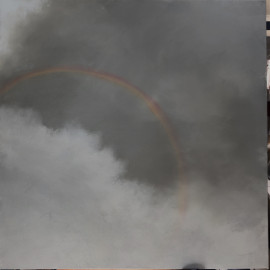 A rainbow against a dark storm cloud